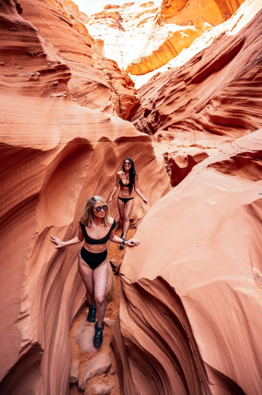 girls in bikini hiking antelope canyon after paddling lake powell