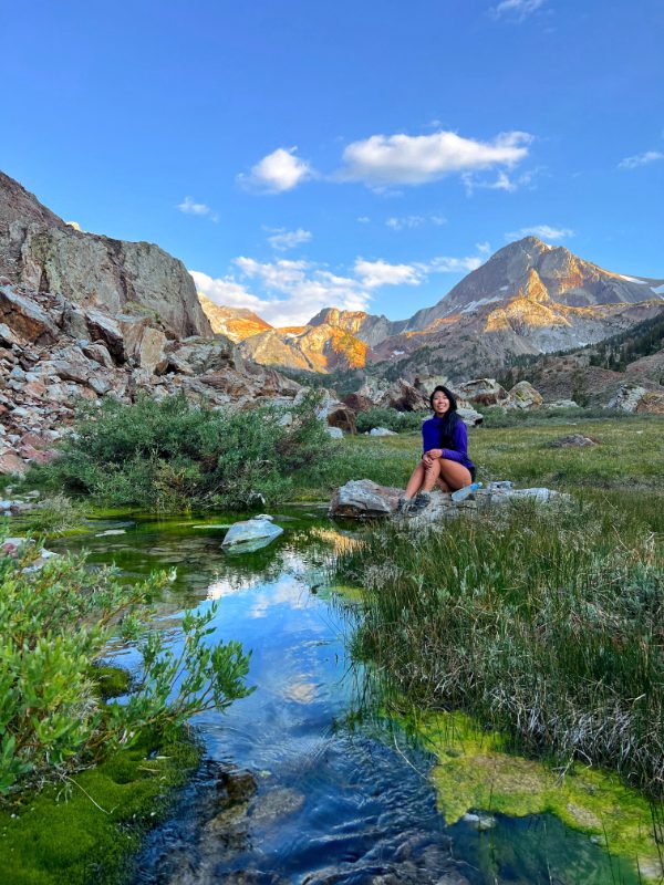 sunset at red slate mountain and girl sitting at creek in eastern sierra