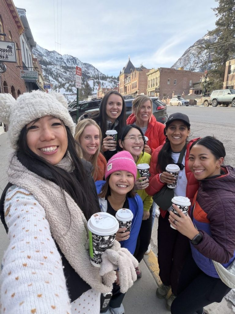Women enjoying welcome hot chocolate in Ouray during the 2026 ice climbing retreat