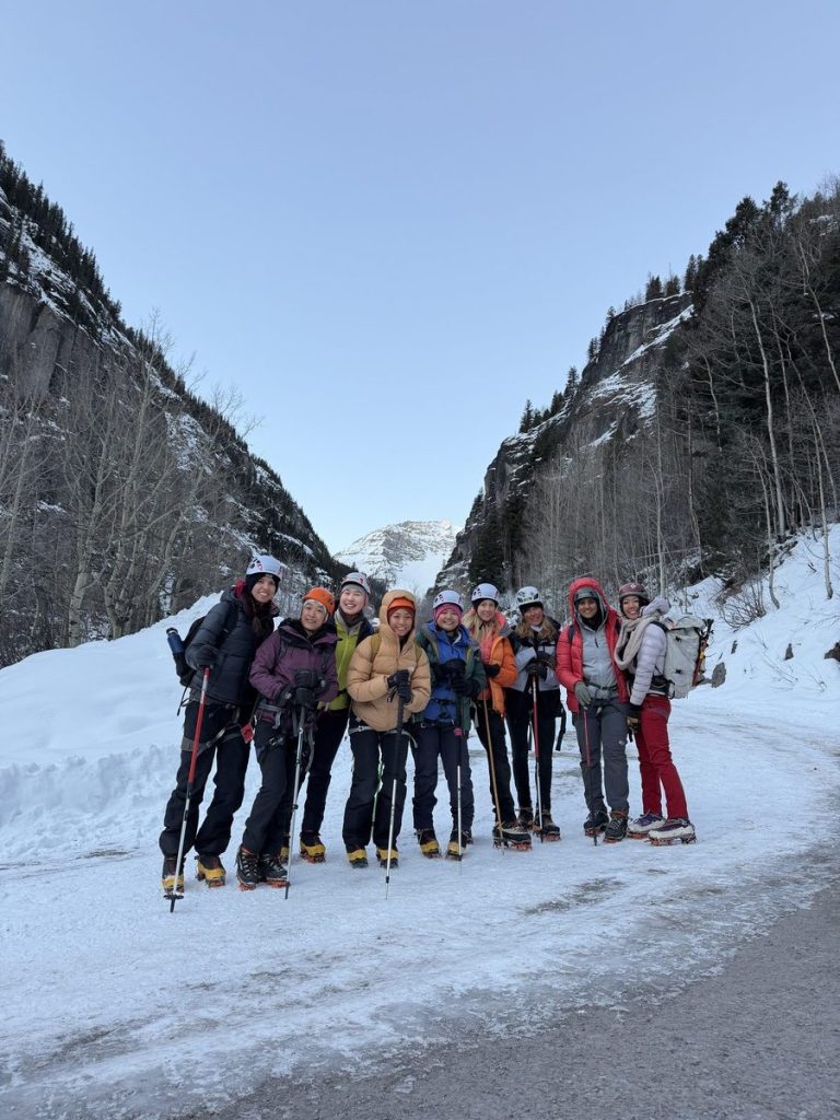 The 2026 women’s ice climbing group posing in the snowy Ouray canyon