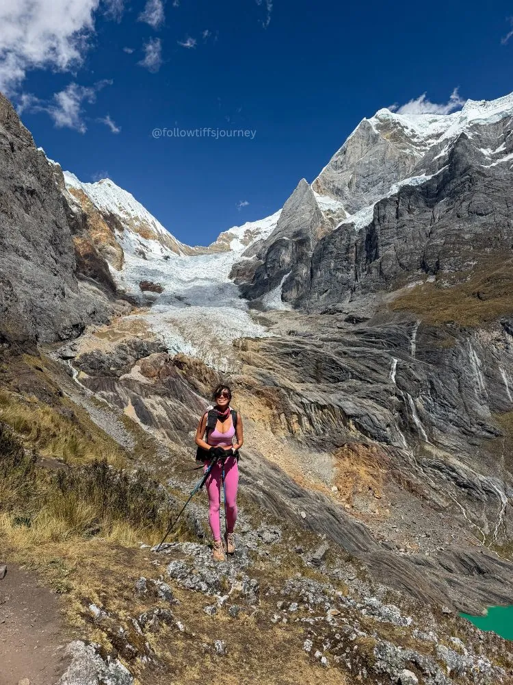 Tiff hiking with trekking poles beneath the Huayhuash peaks